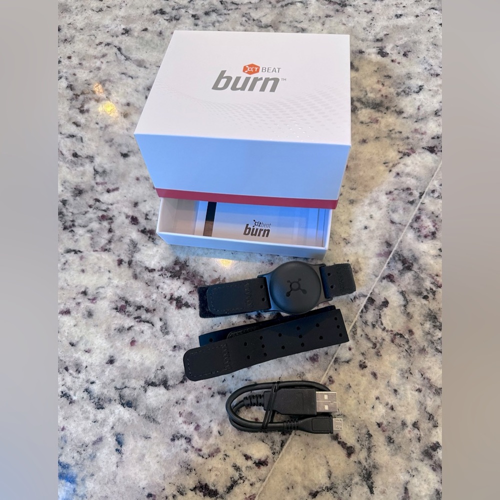 Orange Theory Burn heart rate monitor. Comes with charging cord, 2 wrist bands.